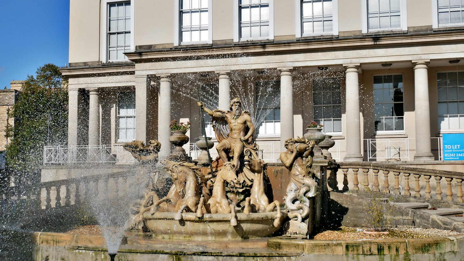The Neptune Fountain on the Promenade in Cheltenham, in front of a Regency terrace