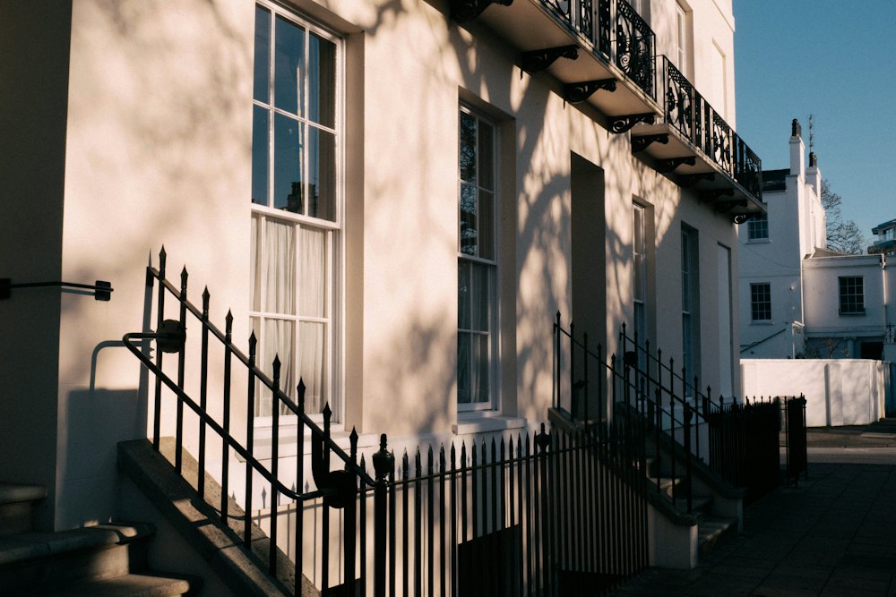 Sunlit Regency townhouses with iron railings and steps up to the front doors